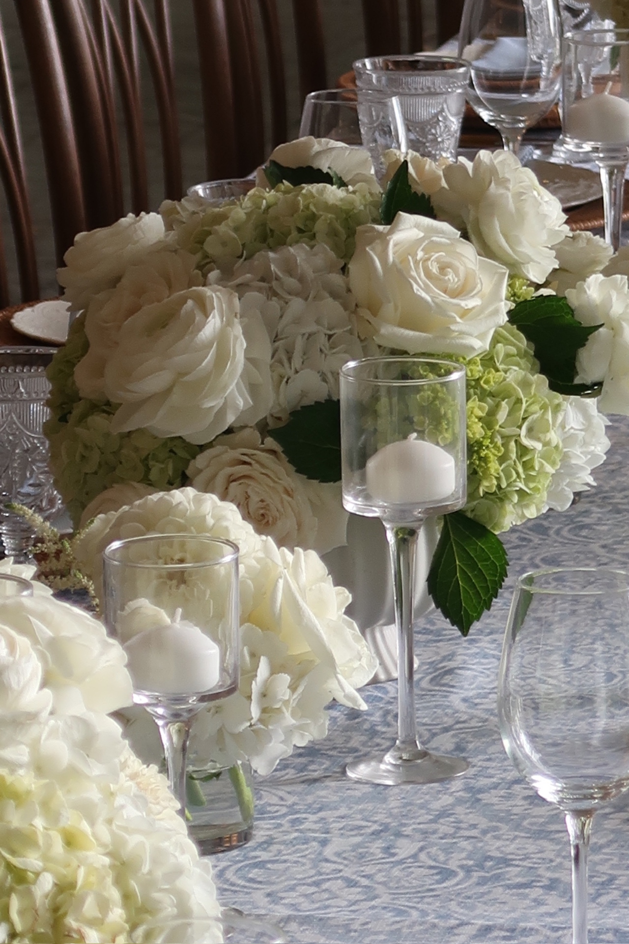 Table setting with a floral centerpiece, candles and crystal glassware
